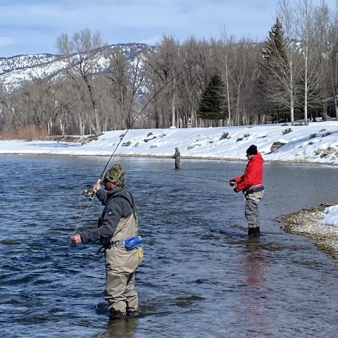 a man riding a snow board in the water
