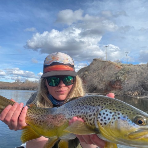 a man holding a fish in the water