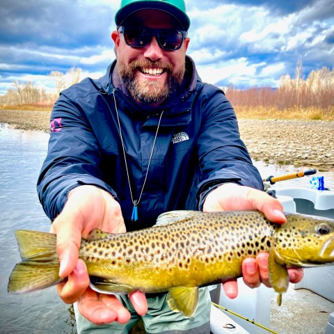 a man holding a fish in the water