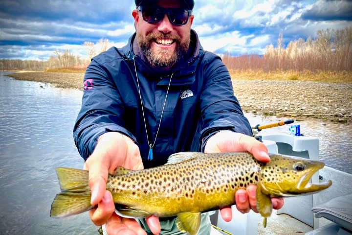a man holding a fish in the water