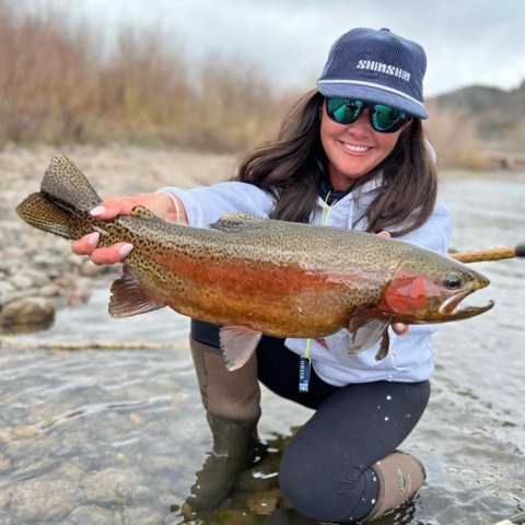 a person holding a fish in the water