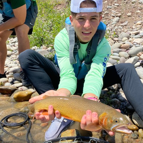 a woman holding a fish