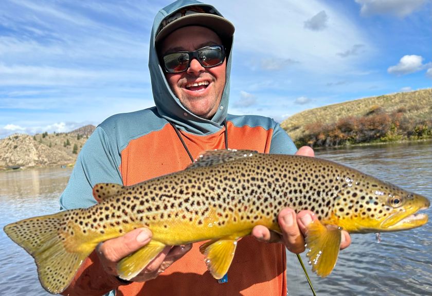 a man holding a fish in the water